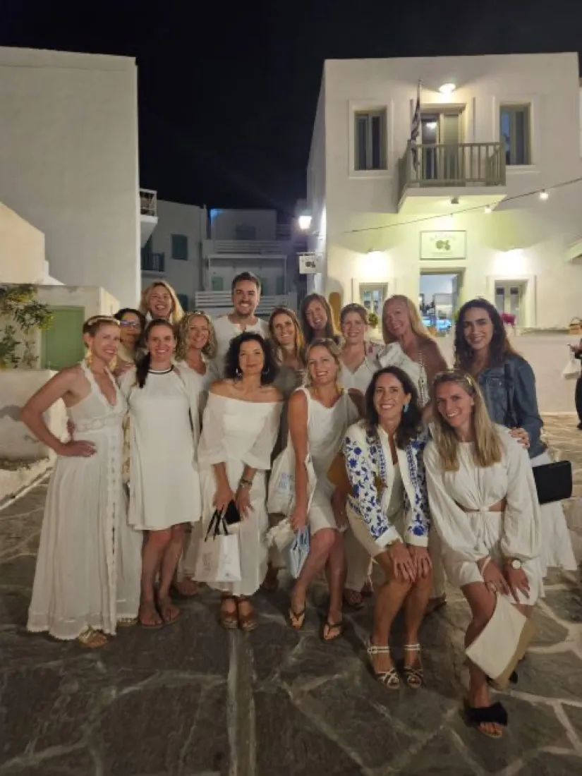 Retreat group dressed in white for dinner in a village square